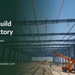 Steel PEB frames being erected with a crane on a factory site
